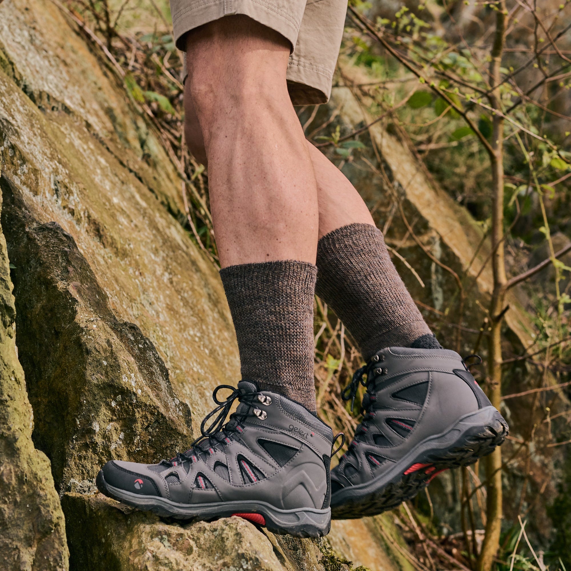 Person wearing hiking boots, socks and shorts on a rocky trail