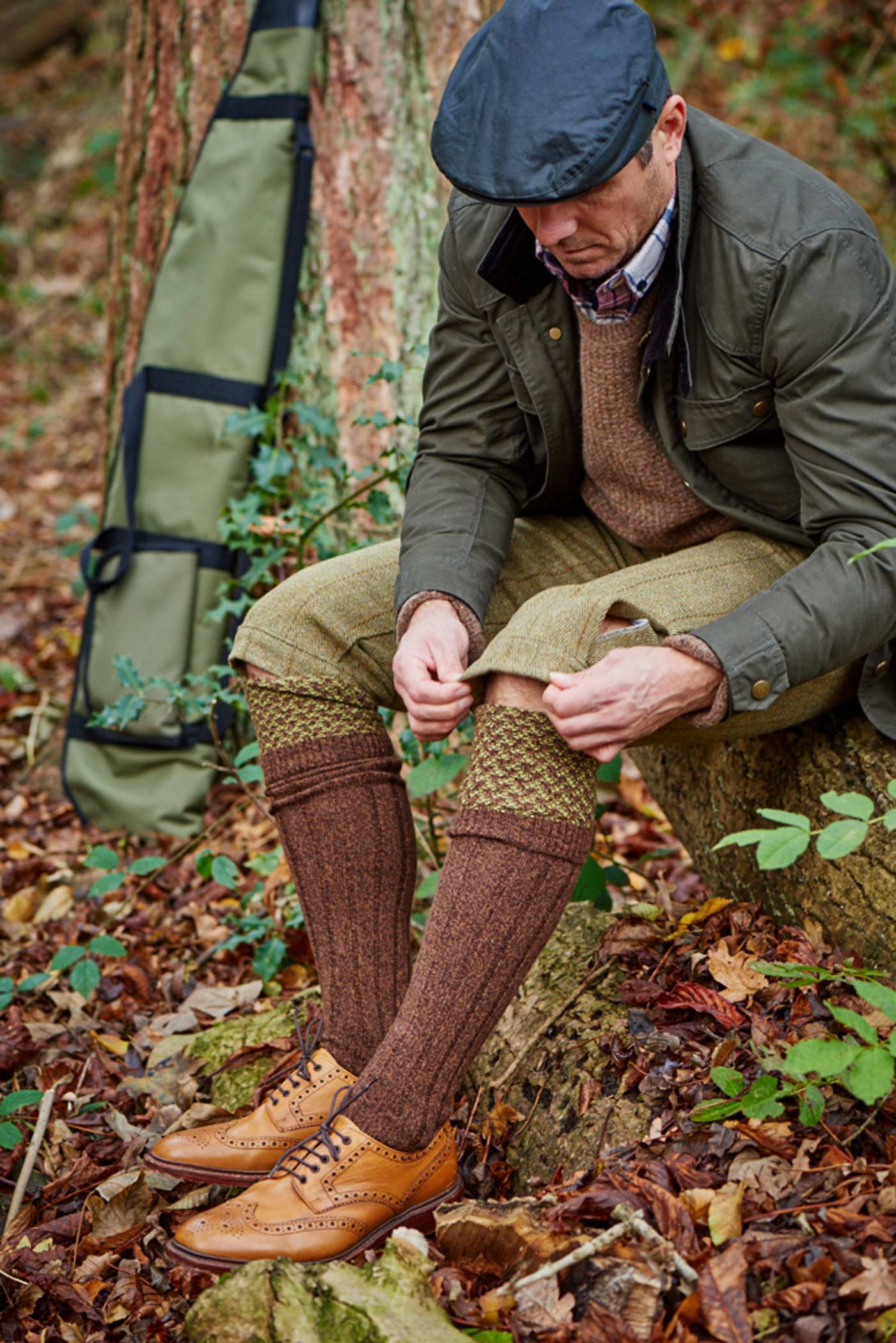 HJ Hall Honeycomb Texture Shooting Socks - Hatfield in Conker Marl – seated wearing socks